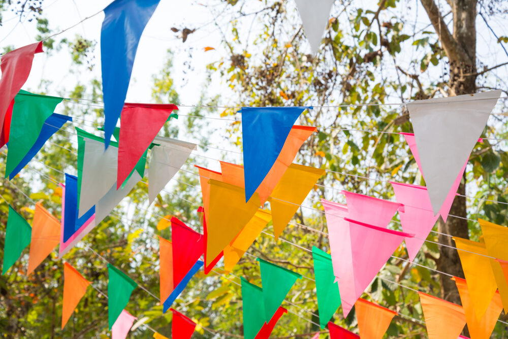 Bunte Wimpelkette zwischen Bäumen